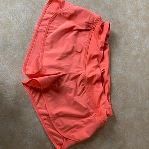 Orange Lululemon running shorts